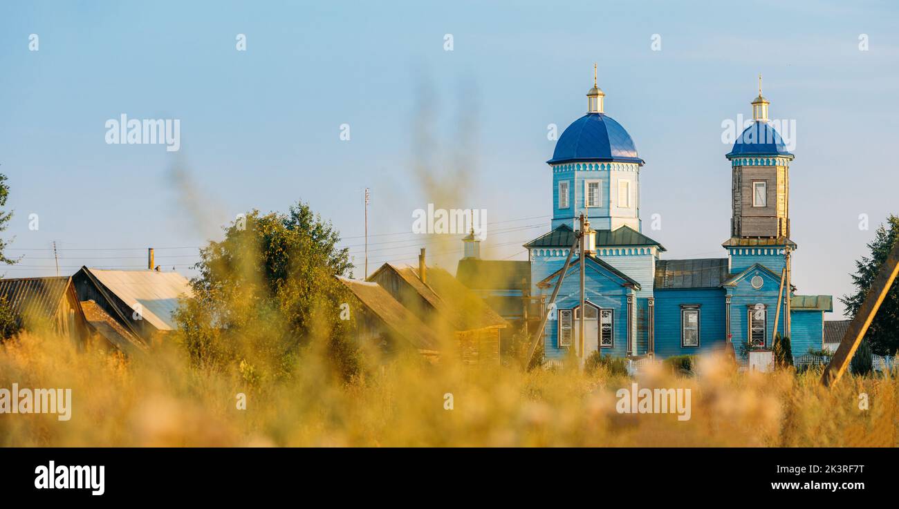 Old wooden orthodox church of the nativity of the Most Holy Theotokos in sunny summer evening. Architectural monument. Glybotskoye, Gomel Region Stock Photo