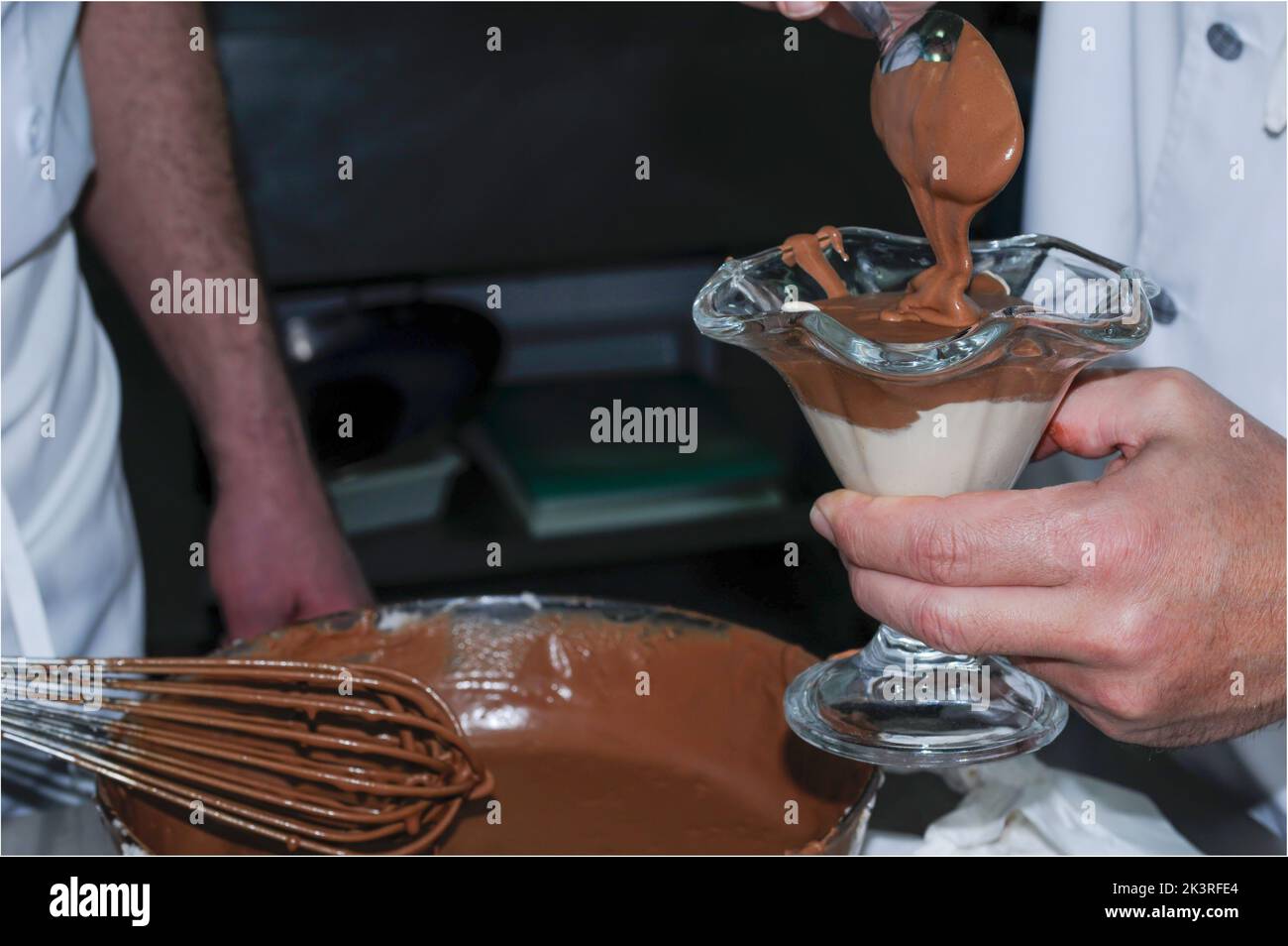 Chef preparing chocolate mousse in a glass cup Stock Photo