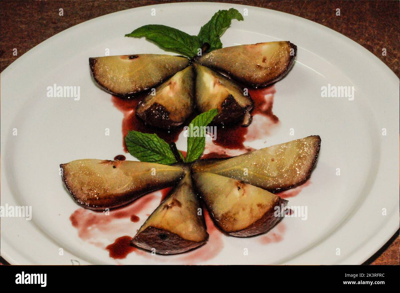 Pears in red wine bathed in their juice Stock Photo