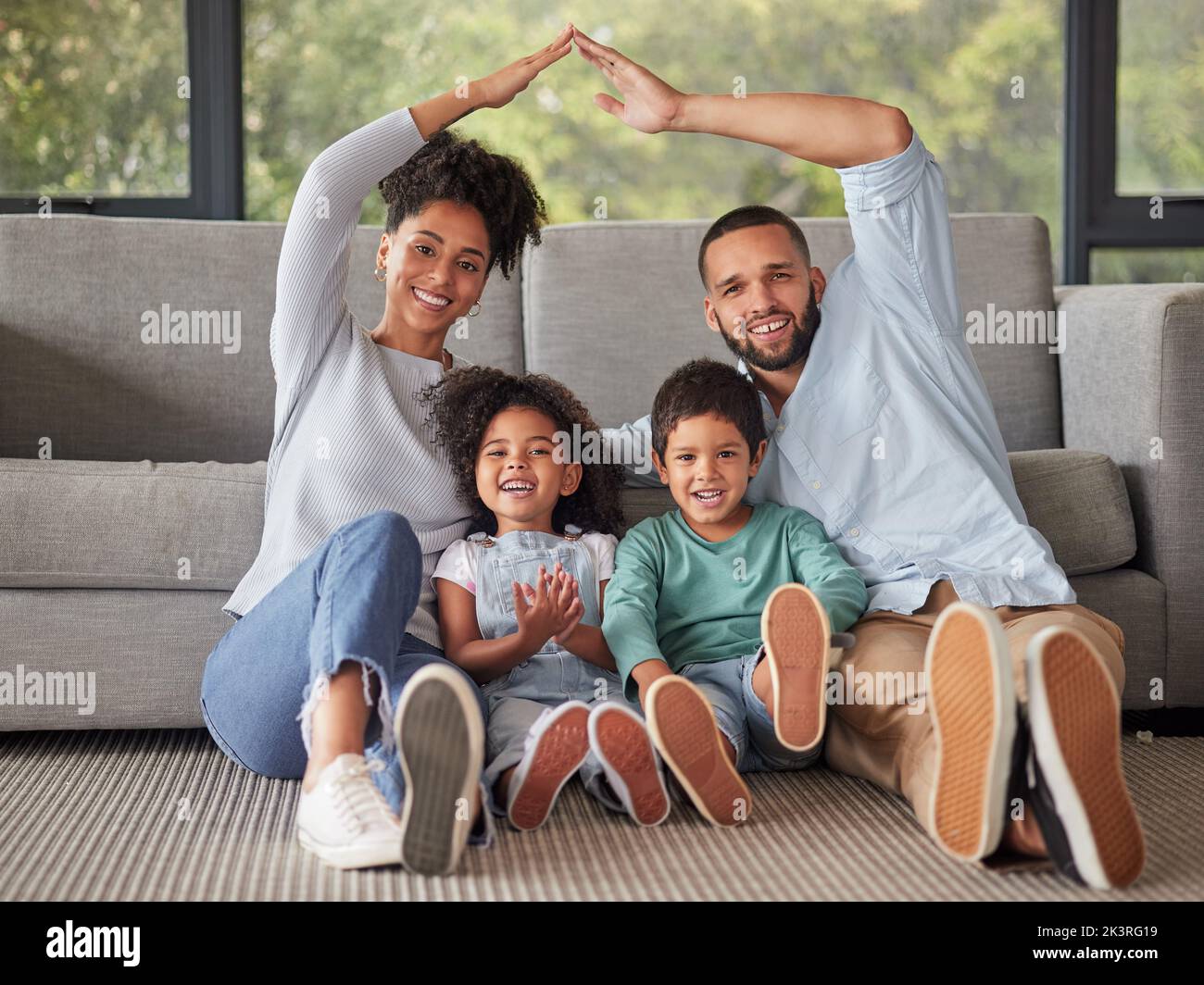 Happy, family and home insurance with roof over kids for protection