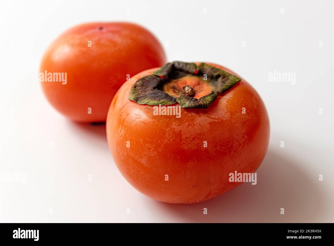 ripe persimmon on a white background Stock Photo