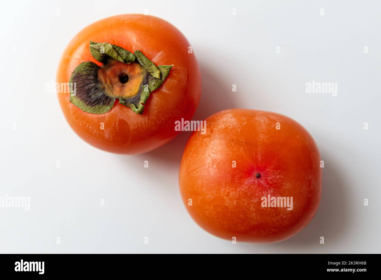 ripe persimmon on a white background Stock Photo