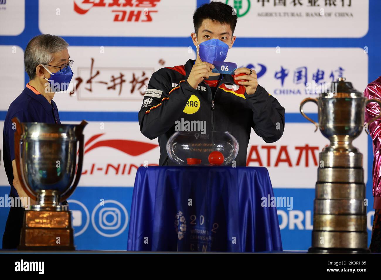 Chengdu, China's Sichuan Province. 28th Sep, 2022. Qiu Dang (R) of Germany shows a draw slip during the draw ceremony of the 2022 ITTF World Team Table Tennis Championships Finals in Chengdu, southwest China's Sichuan Province, Sept. 28, 2022. Credit: Liu Xu/Xinhua/Alamy Live News Stock Photo