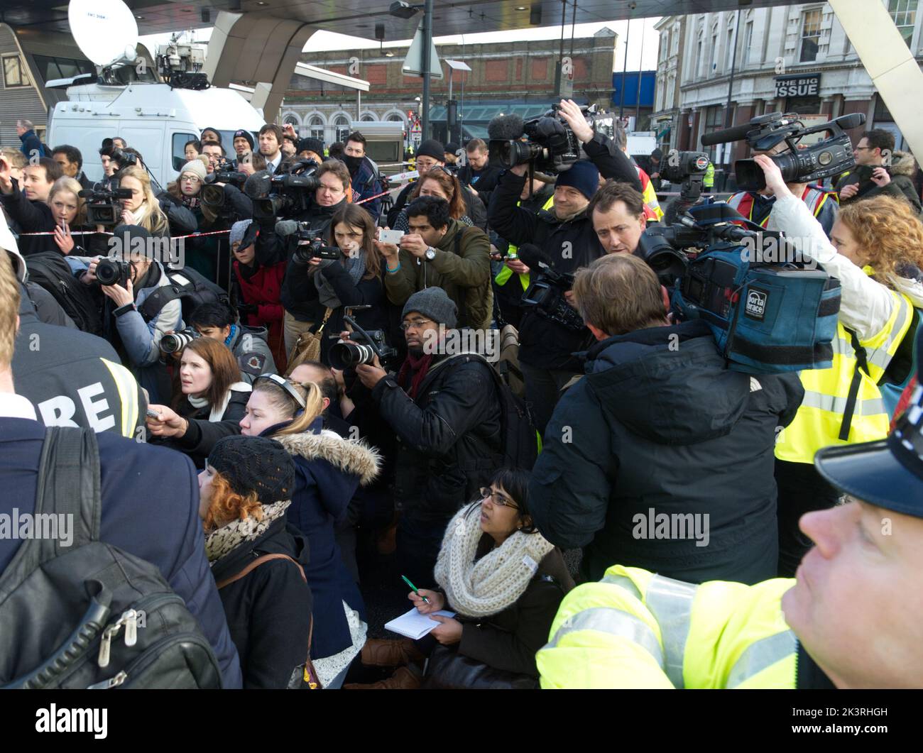 News media photographers, journalists and video crews at a press conference in London following an incident. Stock Photo