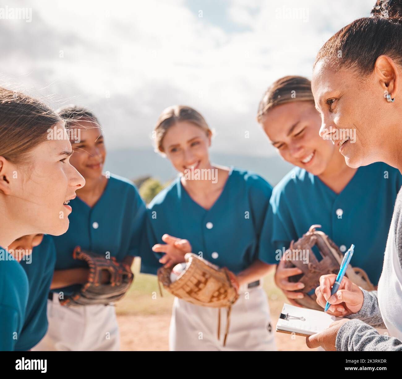 Coach gives strategy to baseball women team, to give them success and secure victory. Female leader talking to inspire motivation, teamwork and Stock Photo