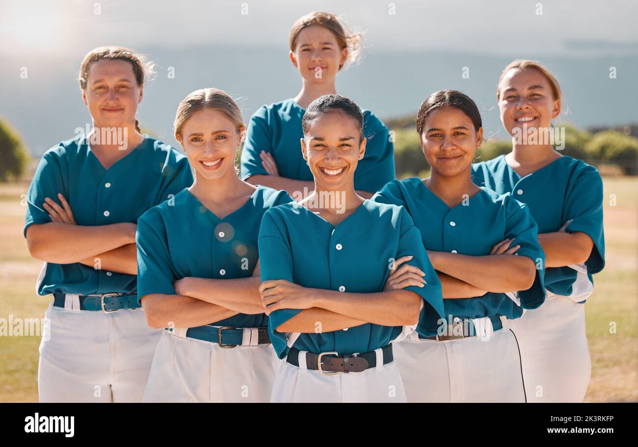 Baseball, happy and women team with arms crossed on a sport field after practice or a game. Teamwork, collaboration and support with a proud group of Stock Photo