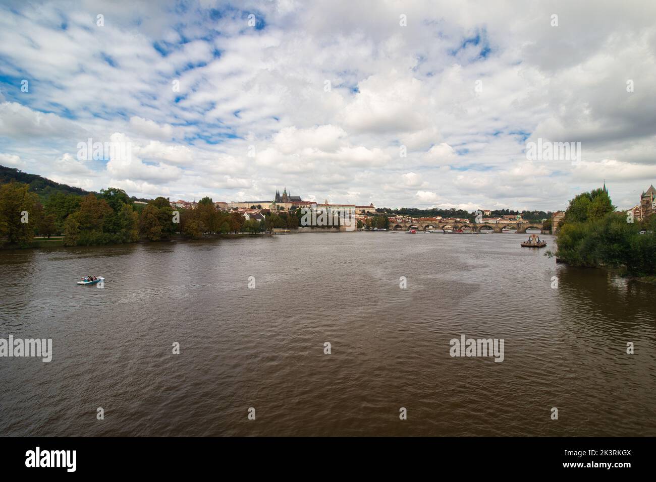 Vltava river , Charles bridge and Prague Castle in background in cloudy summer day. Stock Photo