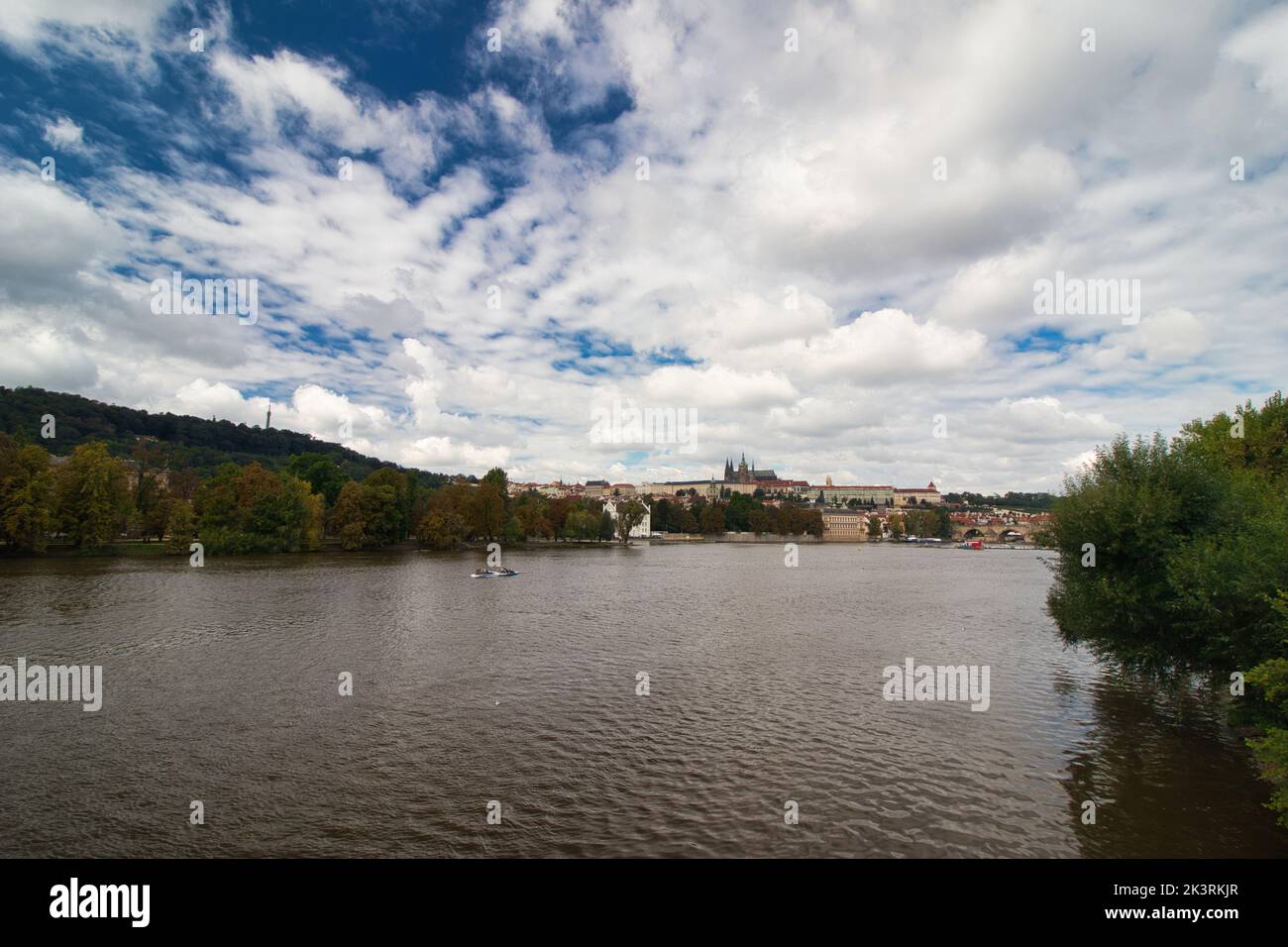 Vltava river , Charles bridge and Prague Castle in background in cloudy summer day. Stock Photo