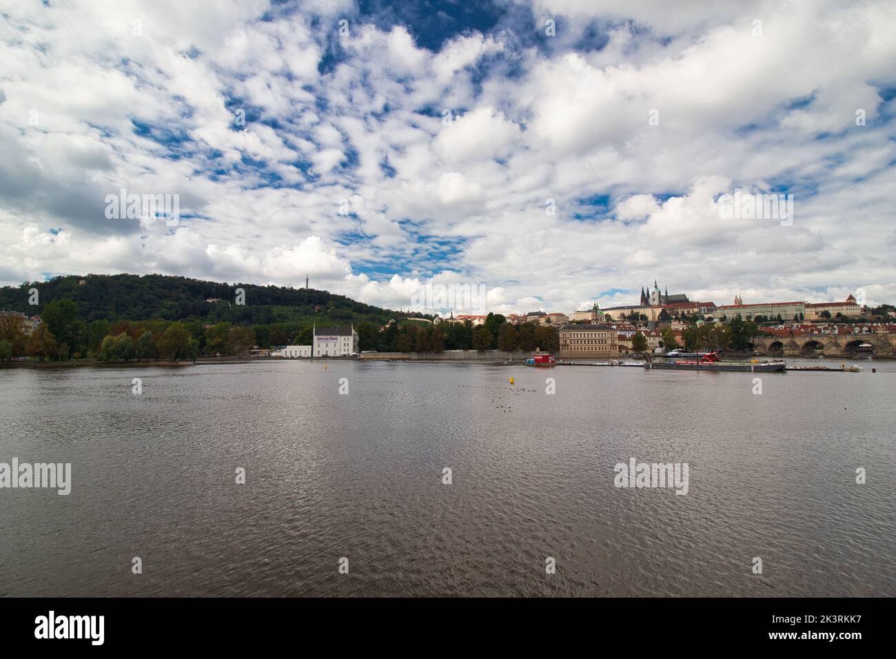 Vltava river , Charles bridge and Prague Castle in background in cloudy summer day. Stock Photo