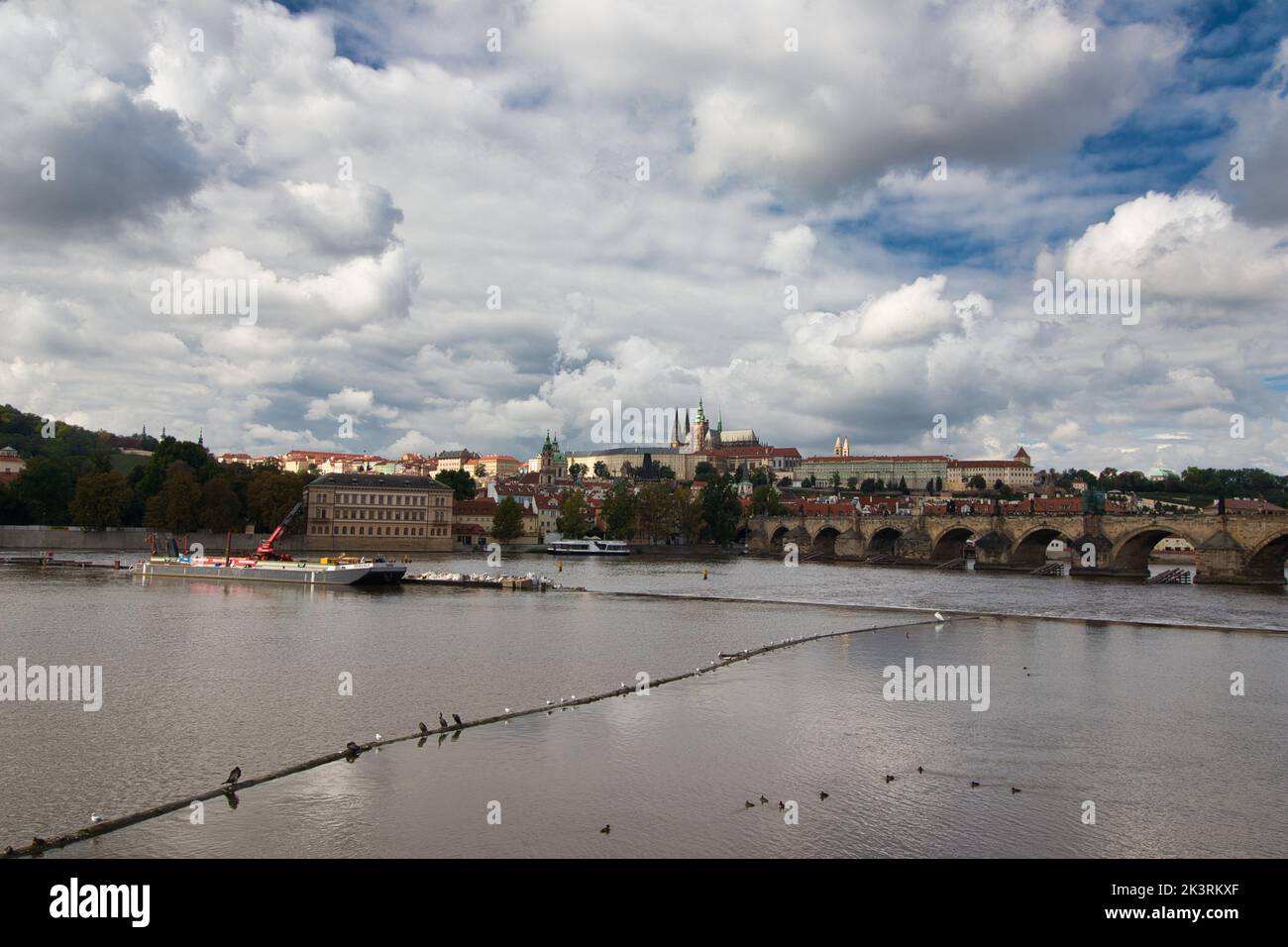 Vltava river , Charles bridge and Prague Castle in background in cloudy summer day. Stock Photo