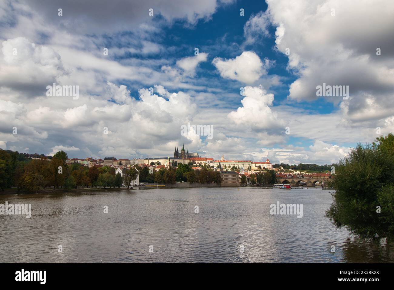 Vltava river , Charles bridge and Prague Castle in background in cloudy summer day. Stock Photo