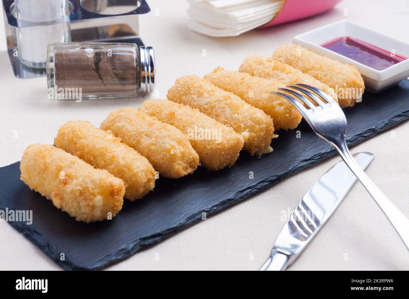 tasty deepfried mozzarella cheese sticks with berry sauce Stock Photo