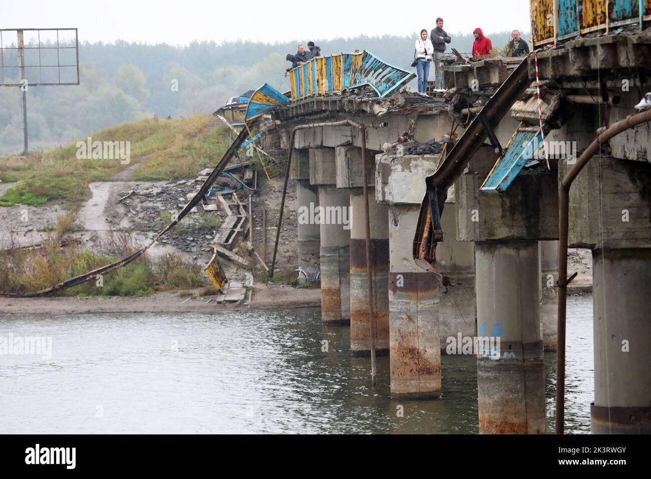 KHARKIV REGION, UKRAINE - SEPTEMBER 27, 2022 - People stand on the bridge across the Pechenihy Reservoir that was destroyed by Ukraine's Armed Forces Stock Photo