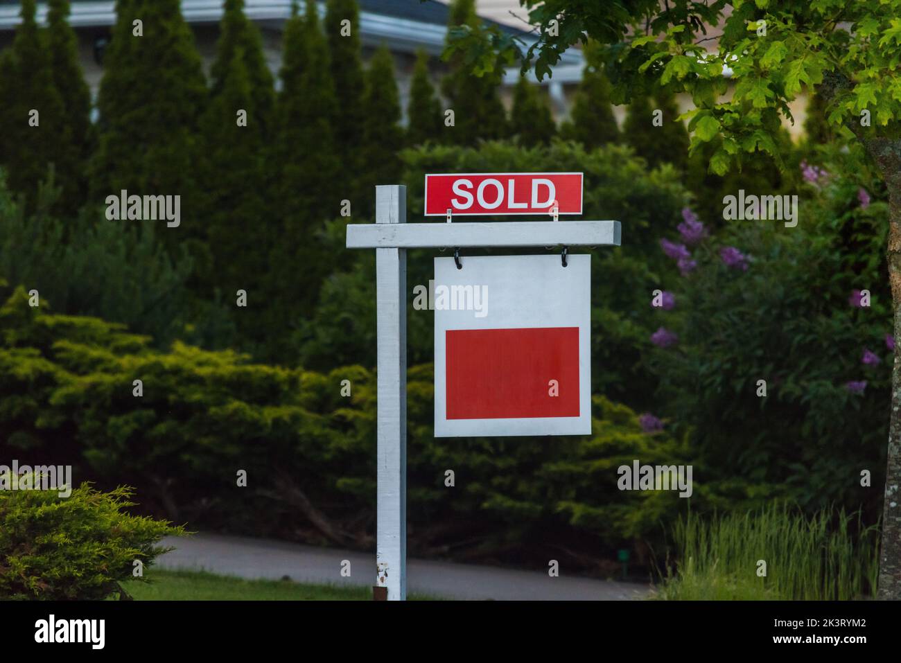 Real state agency SOLD sign. Real estate market property sold sign in front of new house. Copy space for Text. Stock Photo