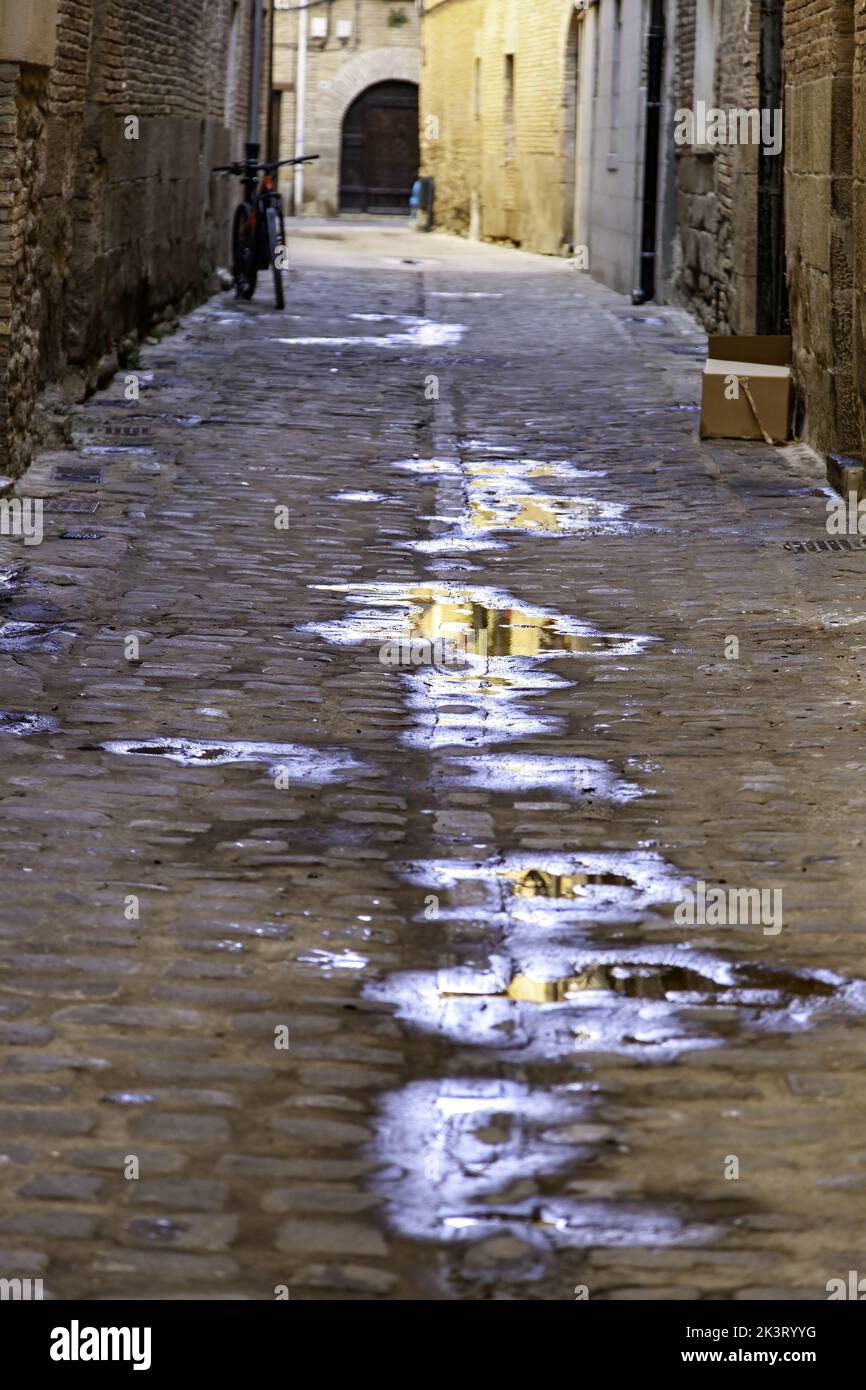 Wet stone street in old town, construction and architecture Stock Photo