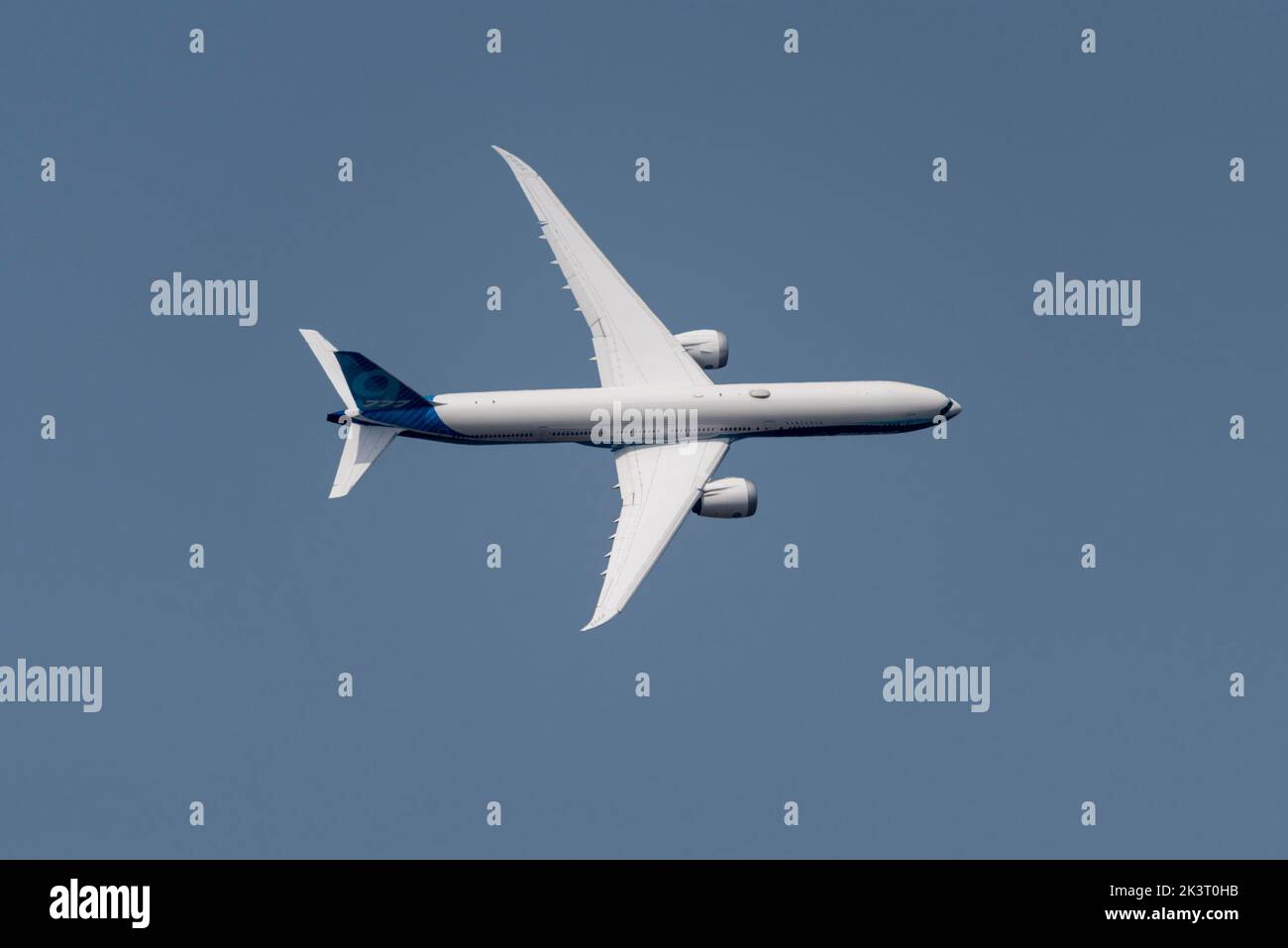 Boeing 777-9, aka Boeing 777X, airliner jet plane flying at Farnborough International Airshow 2022. Top profile view while turning at high bank angle Stock Photo
