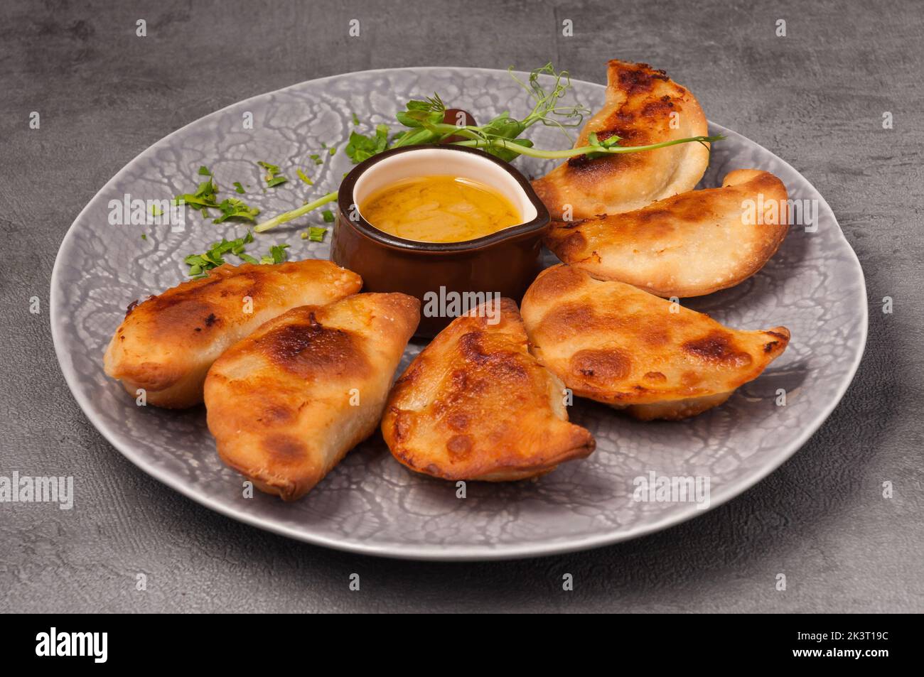 posikunchiki - small pies with meat and mustard sauce Stock Photo