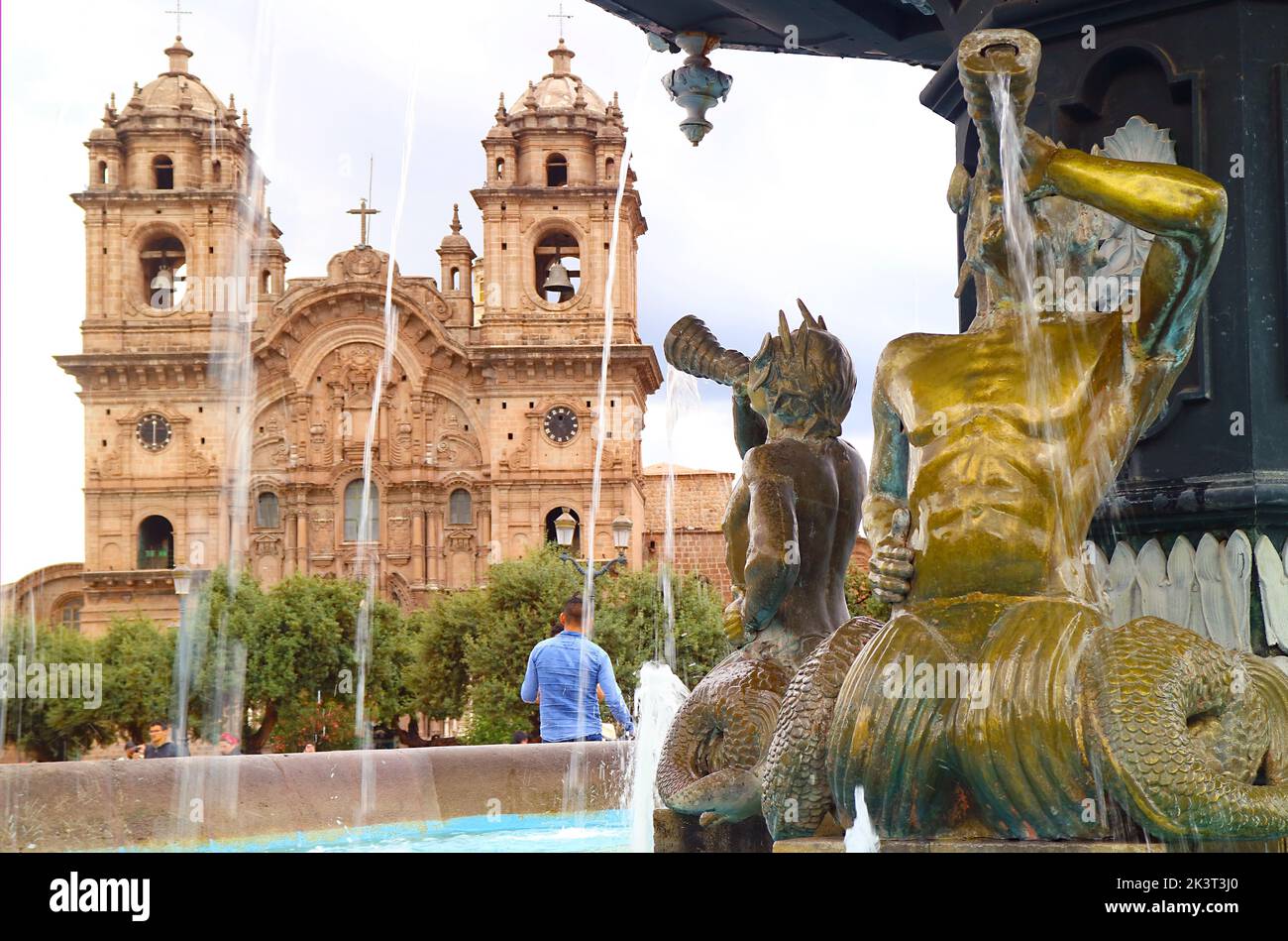 Gorgeous Fountain with Church of the Society of Jesus or Iglesia de la Compania de Jesus in the Backdrop, Historic Center of Cusco, Peru Stock Photo