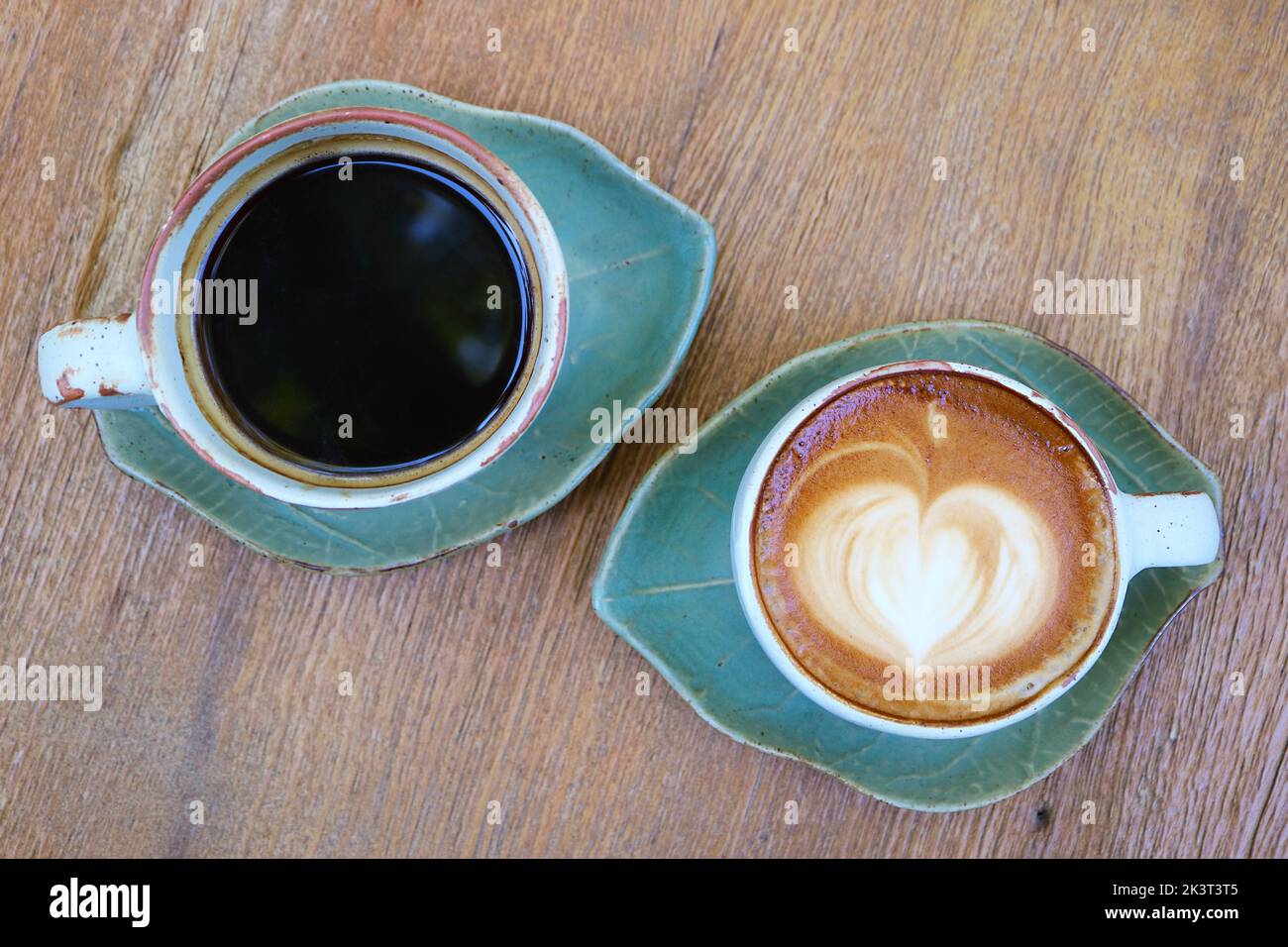 Top view of black coffee and hot cappuccino on wooden table Stock Photo