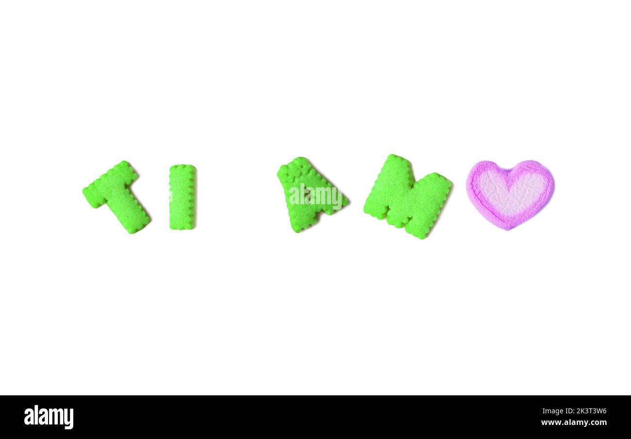 TI AMO, meaning I LOVE YOU in Italian spelled with lime green alphabet cookies and lilac marshmallow on white background Stock Photo
