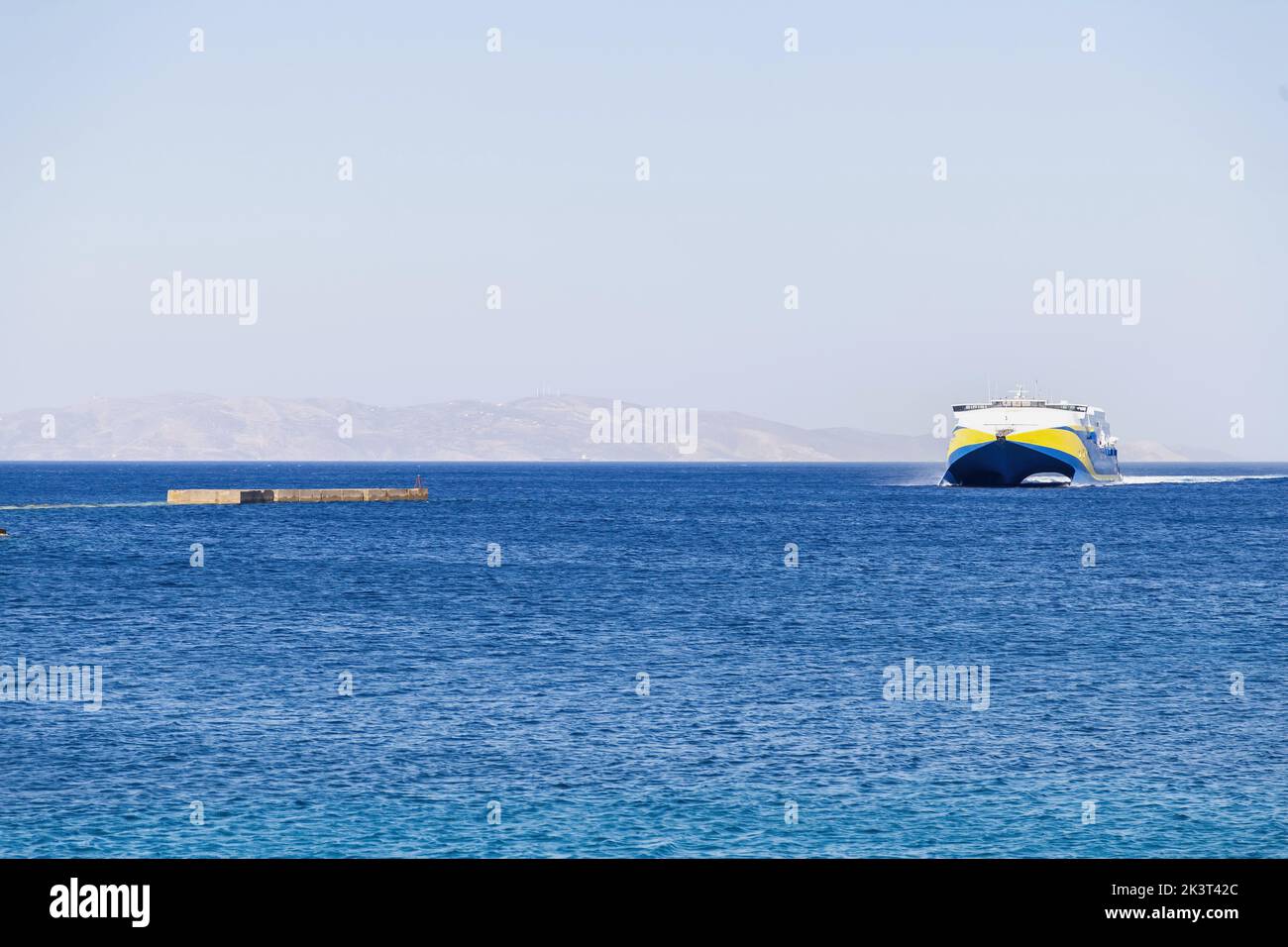Liner ferry boat with destination Greece, Naxos harbor Cyclades islands. High speed vessel in blue vast Aegean sea, clear sky, summer vacation, touris Stock Photo