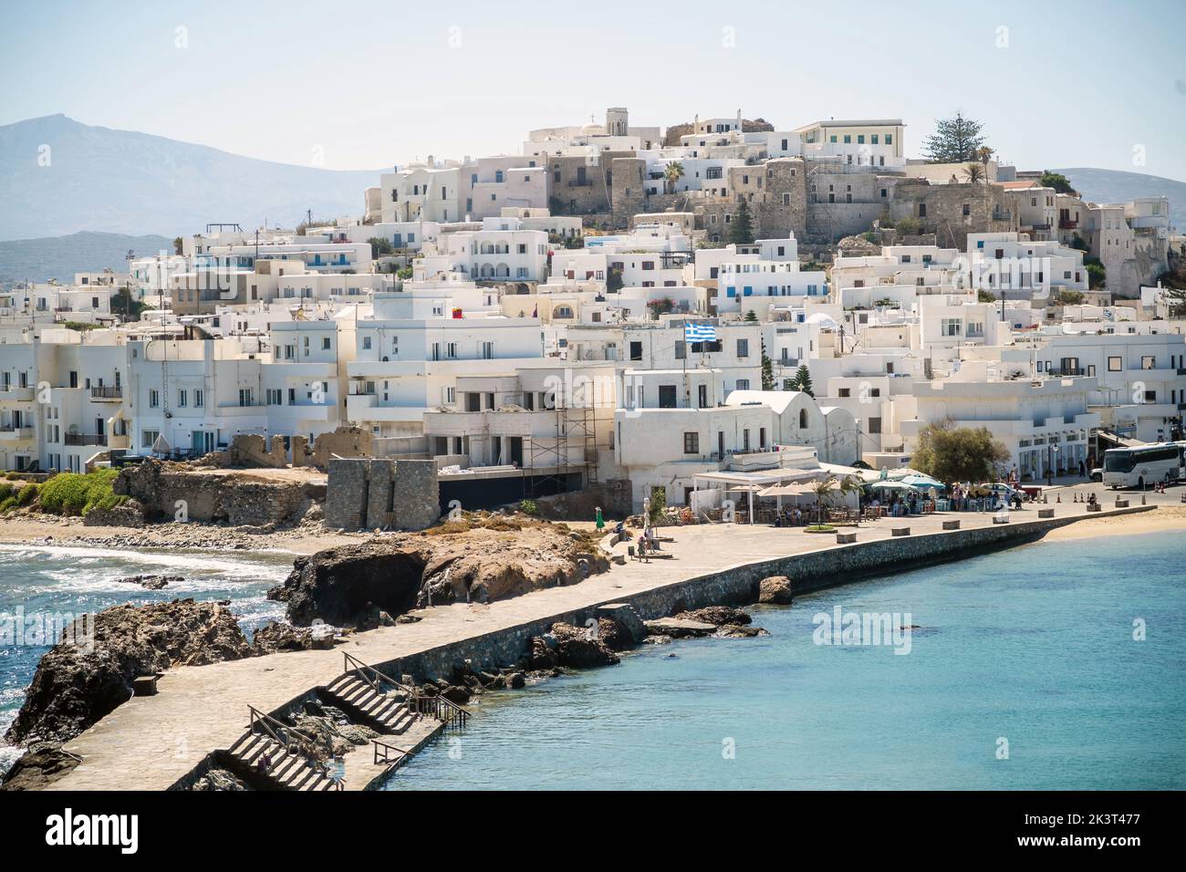 Greece, reaching Naxos harbor jetty, Cyclades islands. View from ship of traditional whitewashed houses perched on the hill. Stock Photo