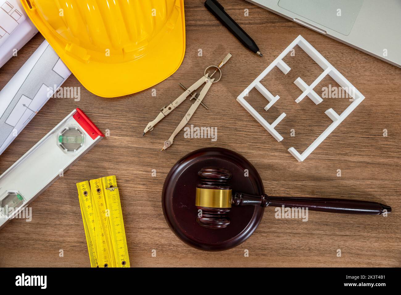 Construction and Labor law flat lay. Judge gavel and design tools on wooden table, top view. Stock Photo