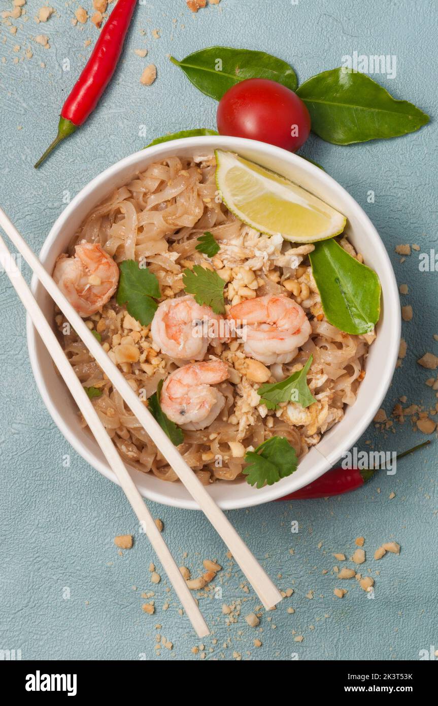 a tasty classic dish of Thai cuisine pad thai with shrimp. vertical