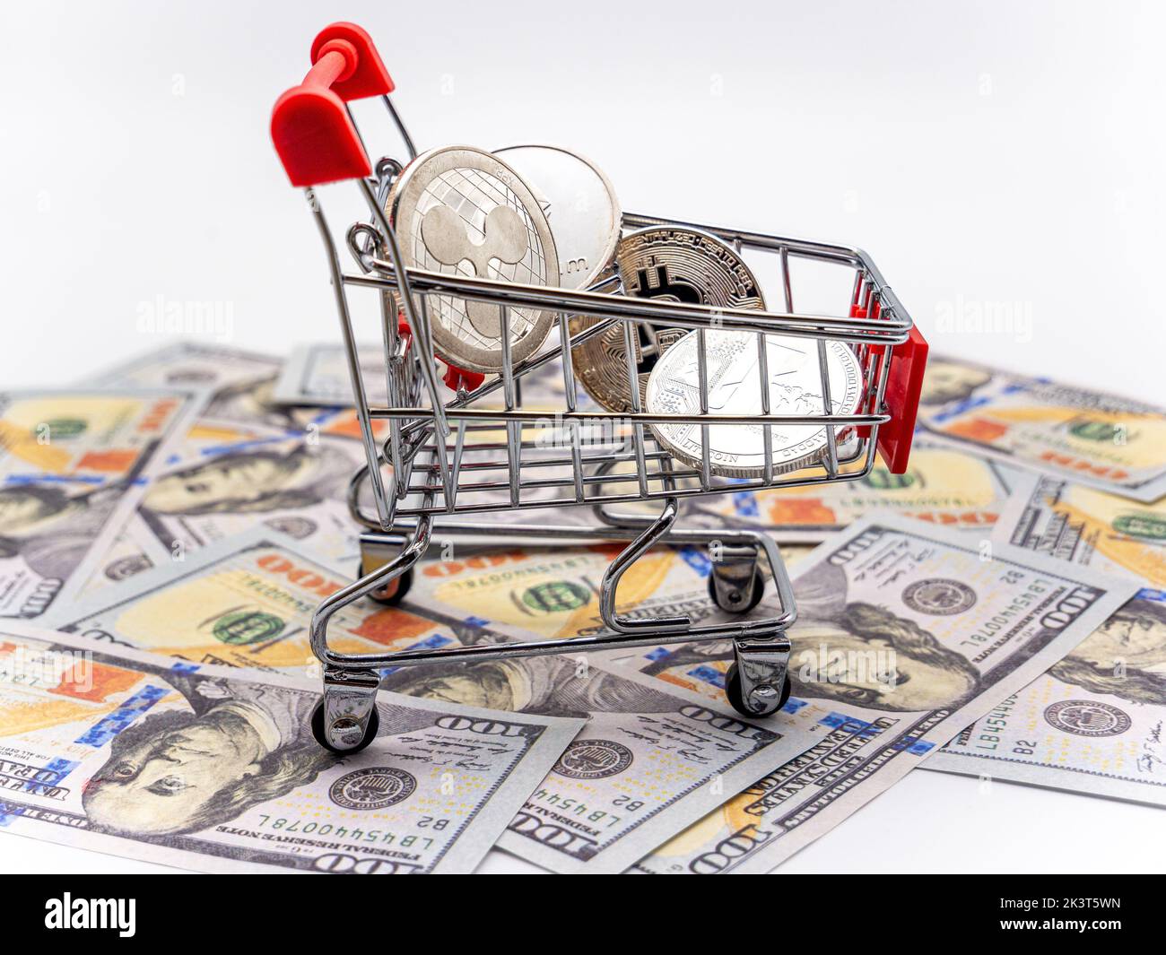 crypto currency bitcoin in shopping cart and dollar money background Stock Photo