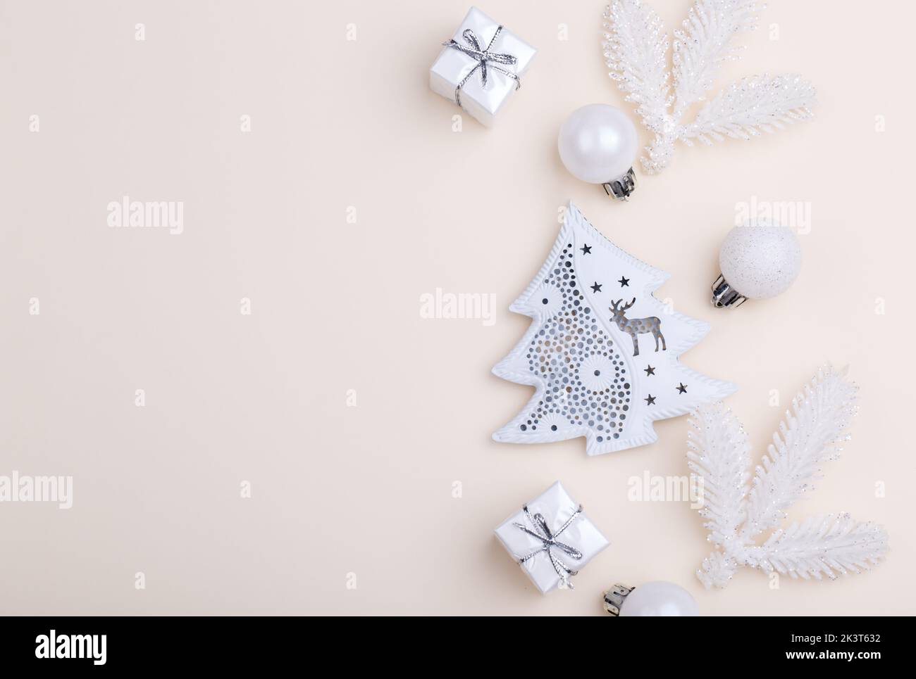 White Christmas ornaments on beige background, flat lay with copy space. Holiday greetings card template Stock Photo