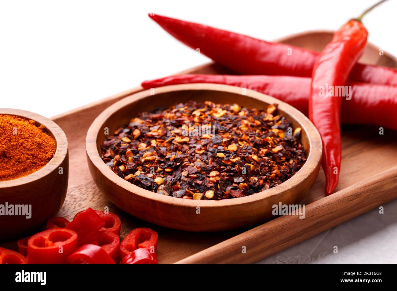 Red chili peppers and flakes on grey stone background copy space top view Stock Photo