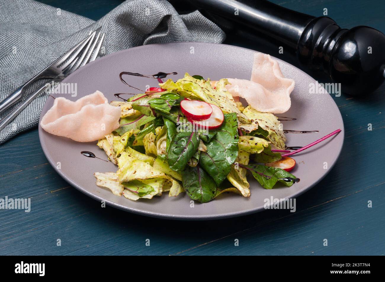 tasty green salad with radish and shrimp chips Stock Photo