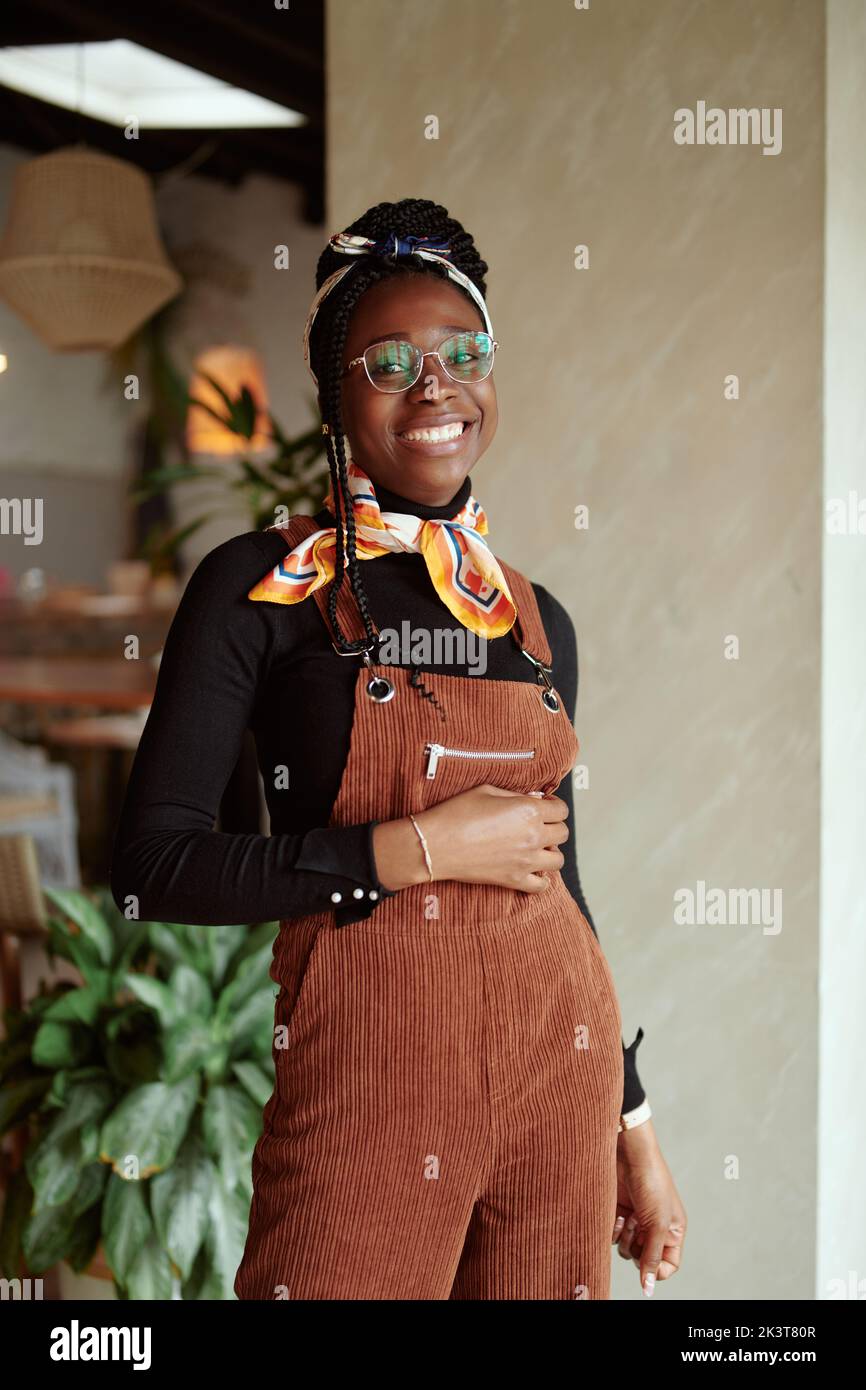 A beautiful African girl posing in cafe and smiling at the camera Stock ...