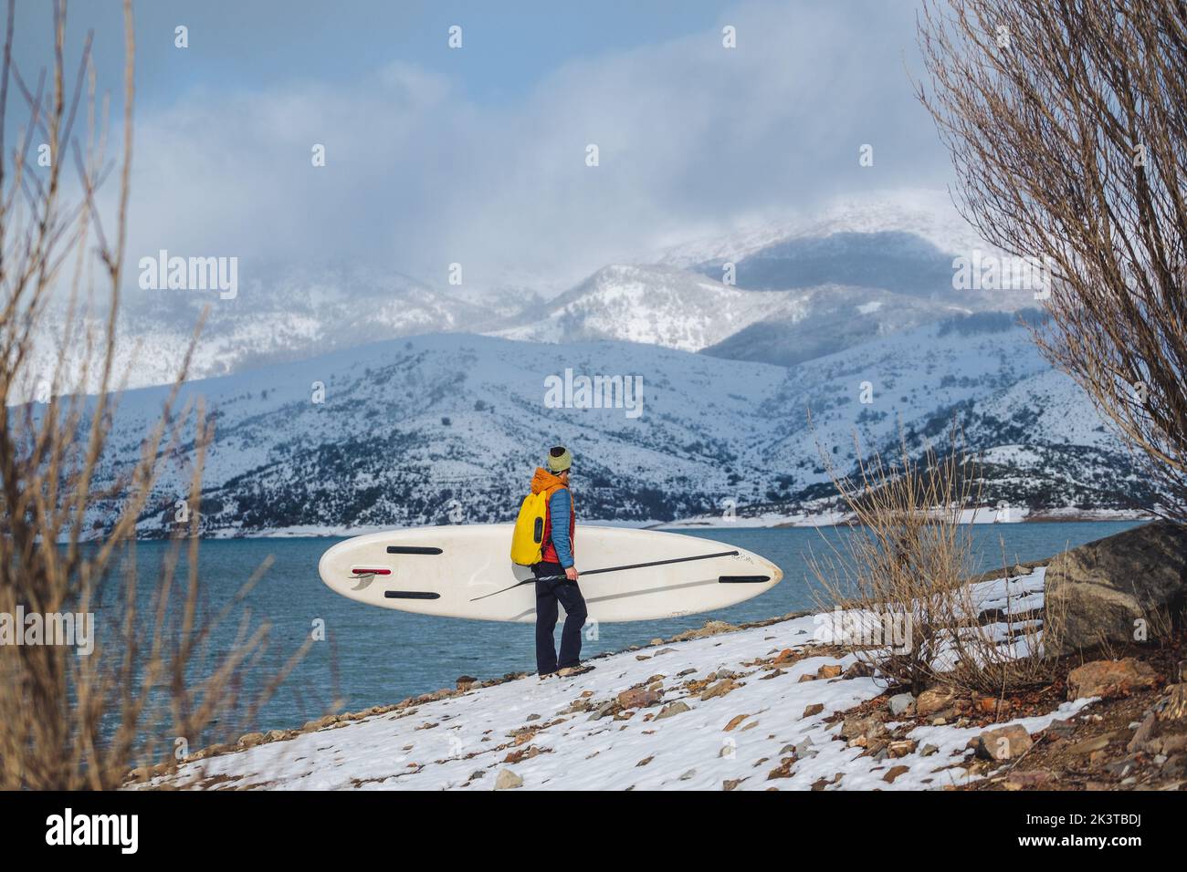 Side view of tourist bringing sup on coast and picturesque view of
