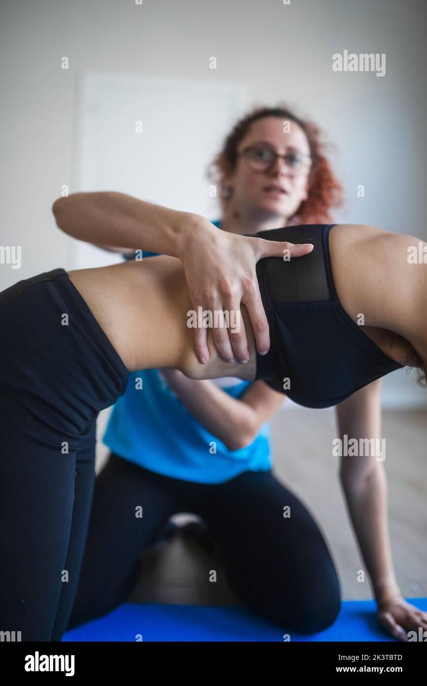 Crop anonymous fit woman in sportswear performing Box pose with help of ...