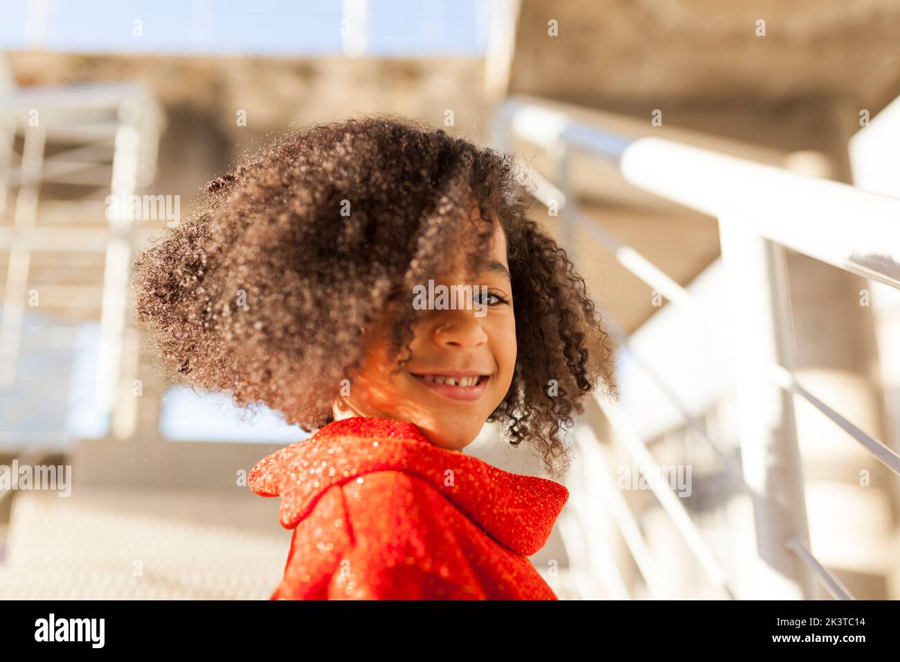 Smiling cute black girl on street looking at camera Stock Photo
