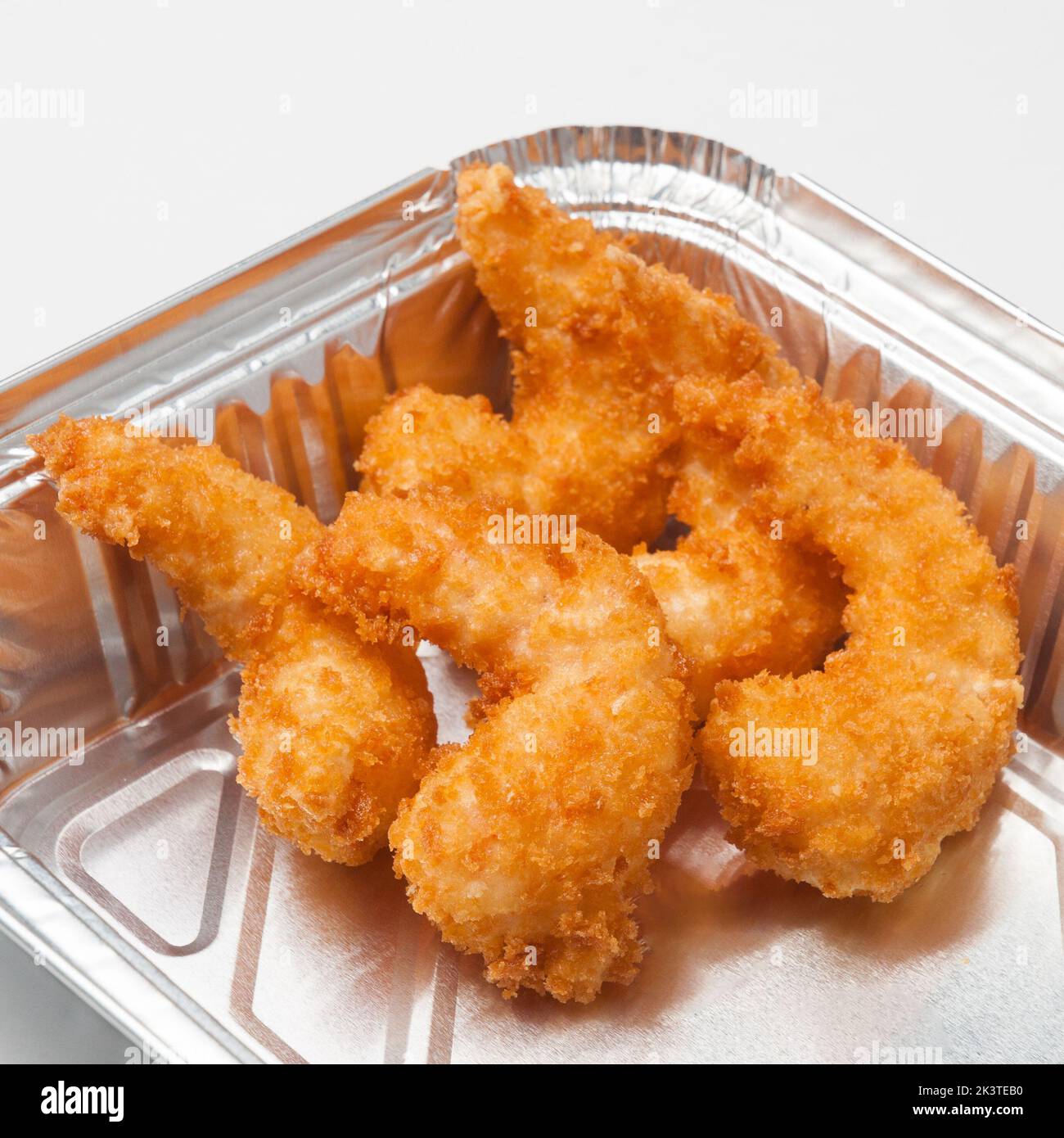 tasty breaded shrimp in a foil container. Concept food delivery, quick snack Stock Photo Alamy