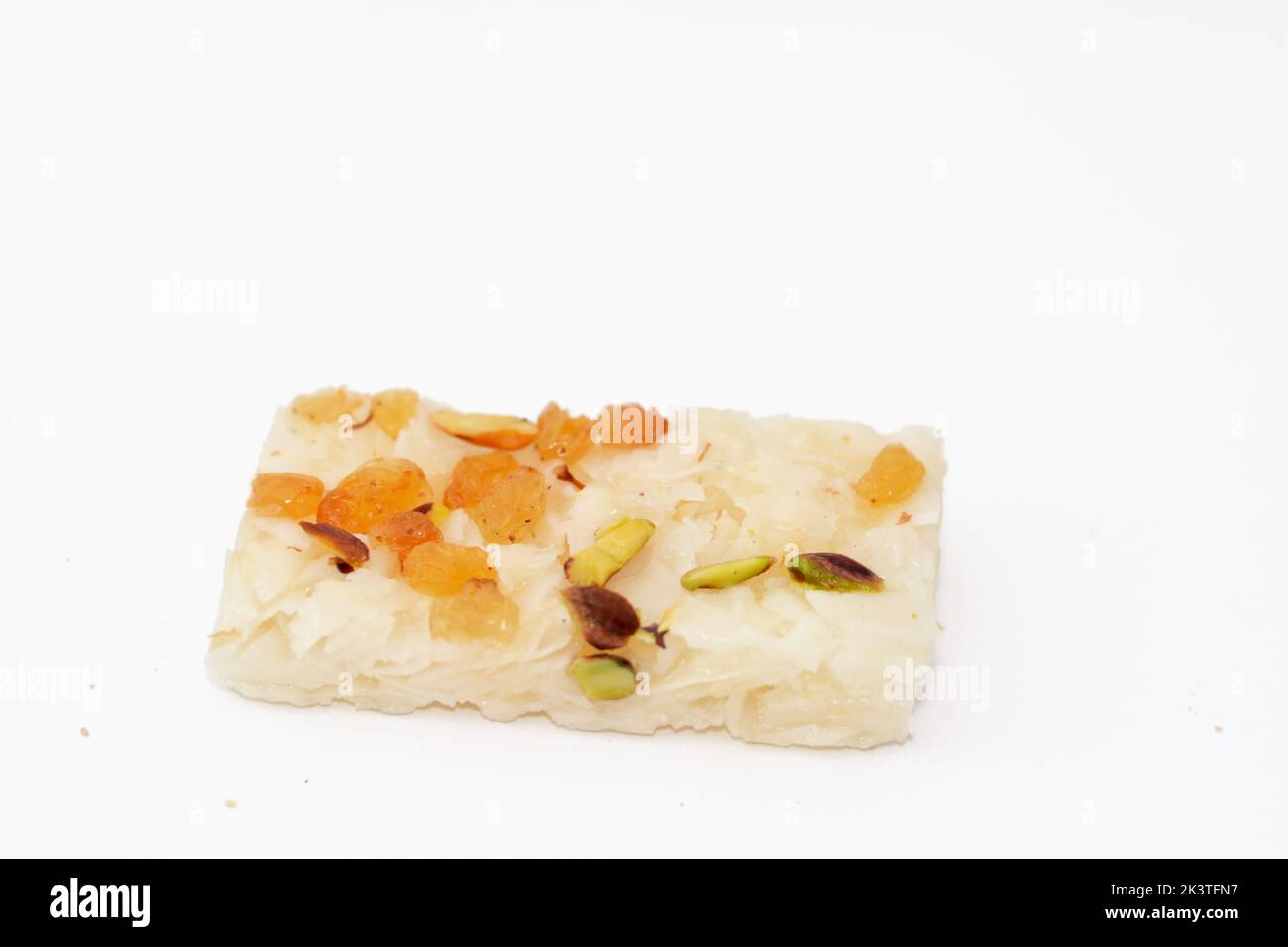 Coconut with raisins and pistachio nut, an Eastern candy made as a ...