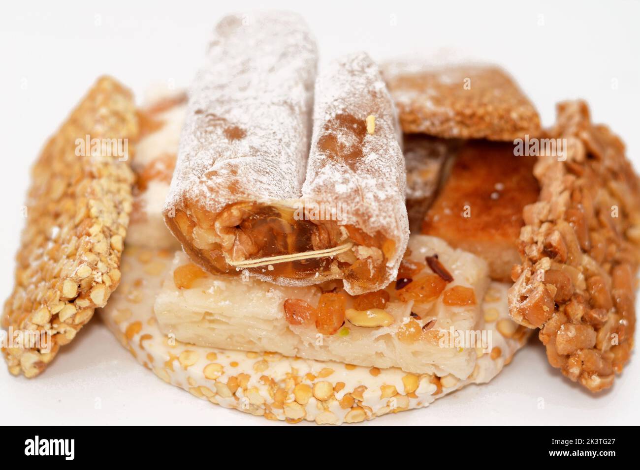 collection of Eastern candy chickpeas, peanuts, sesame, walnuts taffy, coconut and bassima as a celebration of the prophet's Mohamed birthday, Arabian Stock Photo
