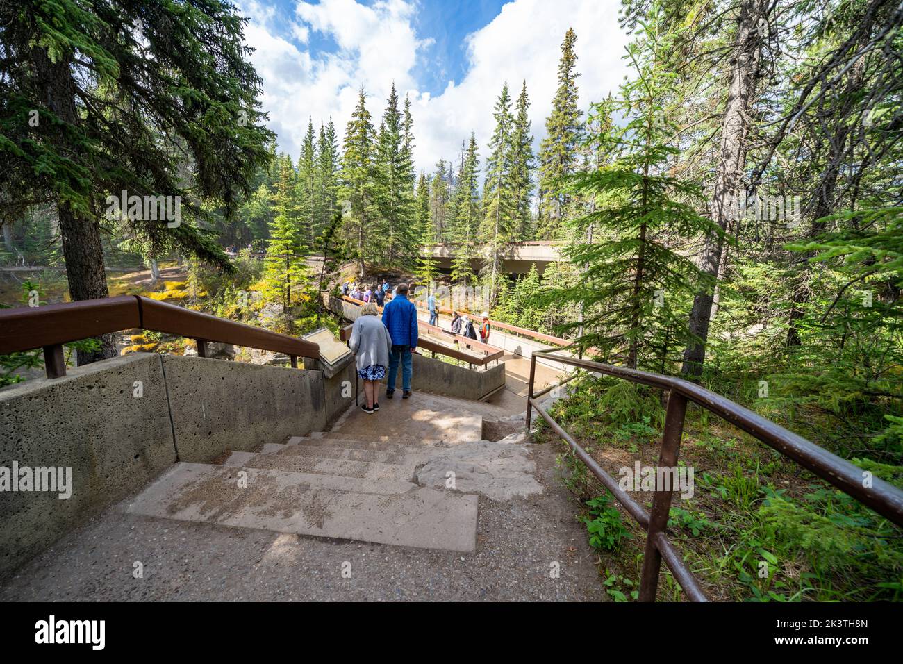Jasper, Alberta, Canada - July 13, 2022: Tourists walk along the network of stairs to see Athabasca Falls waterfall along the Icefields Parkway in Jas Stock Photo