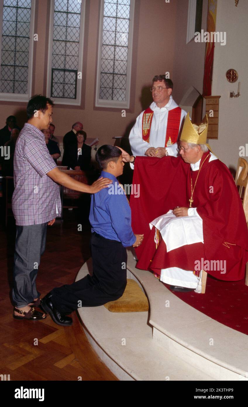 St Josephs Church England Bishop Annointing Candidate at Confirmation Stock Photo