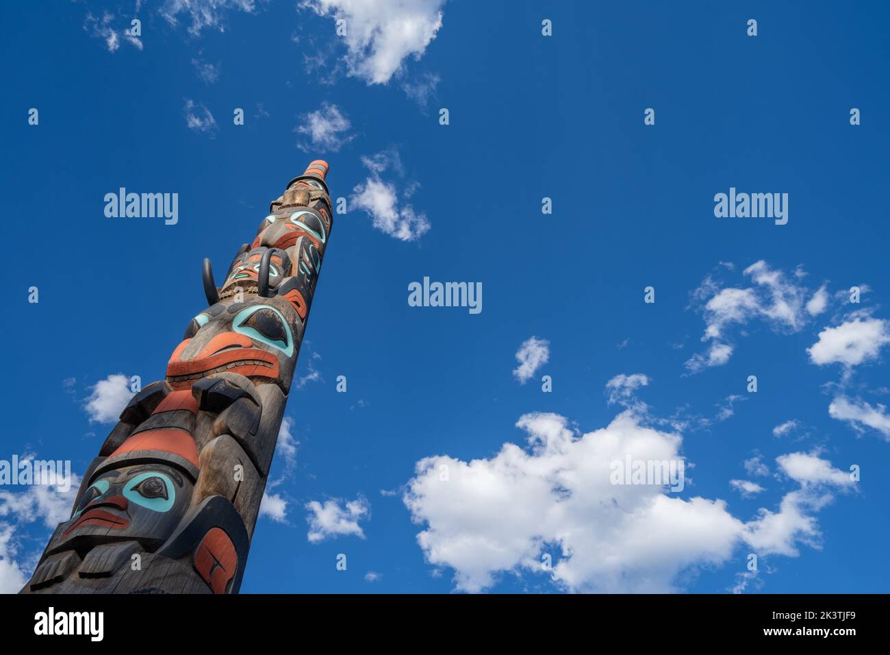 Jasper, Alberta, Canada - July 12, 2022: Totem pole in Jasper National Park against a blue sky Stock Photo