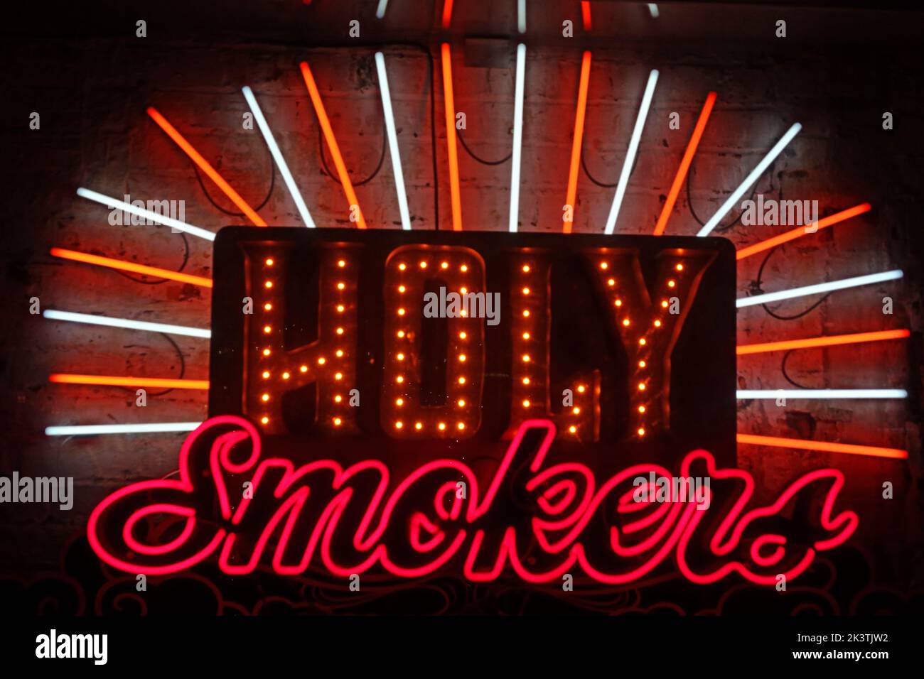 Holy Smokers neon sign, at Reds true BBQ restaurant, 22 Lloyd St, Manchester, England, UK,  M2 5WA Stock Photo