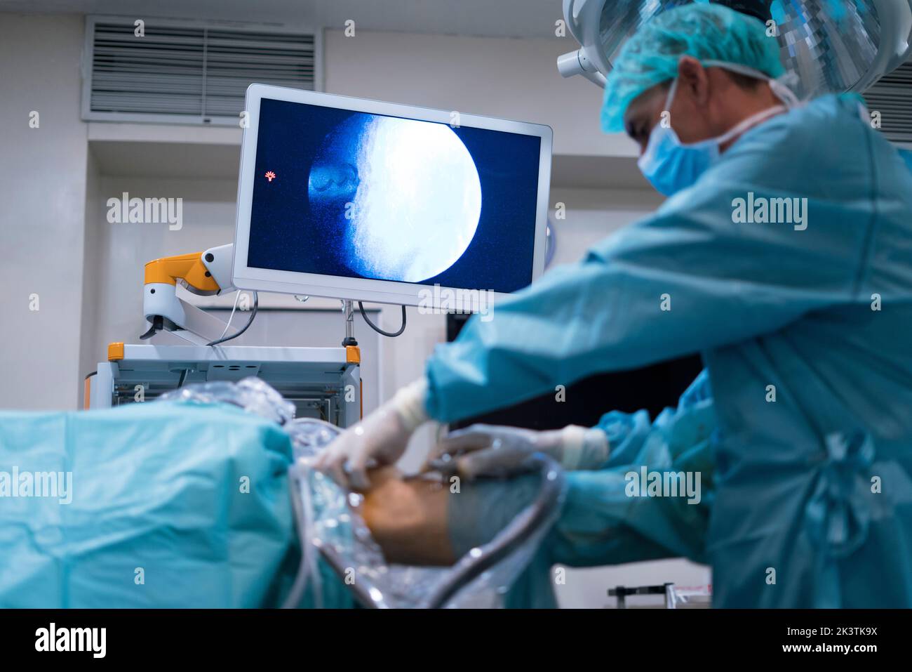 Surgeon conducting surgery through knee Stock Photo