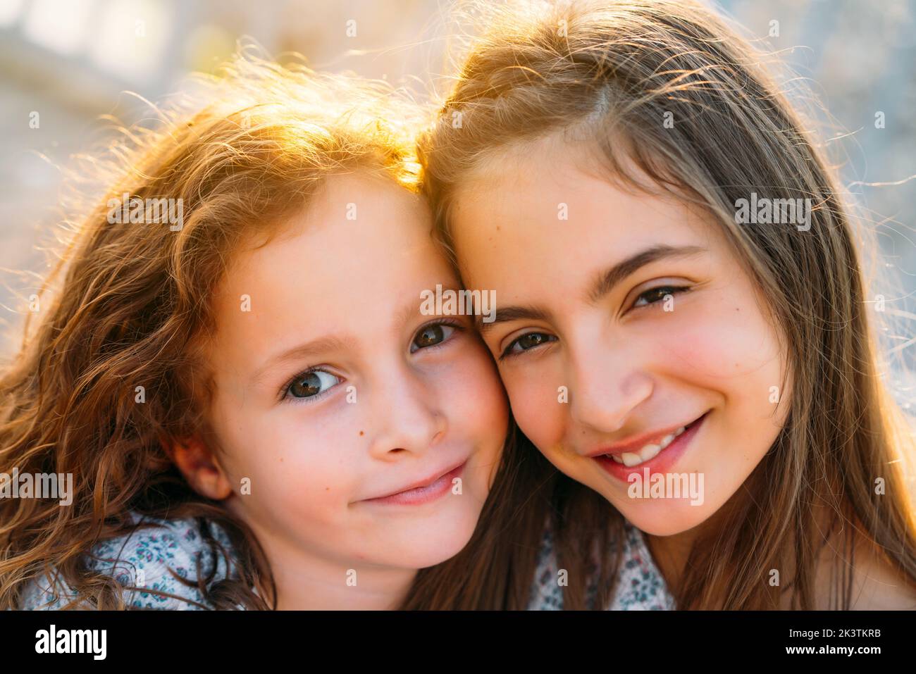 Girls sitting on wooden floor Stock Photo - Alamy