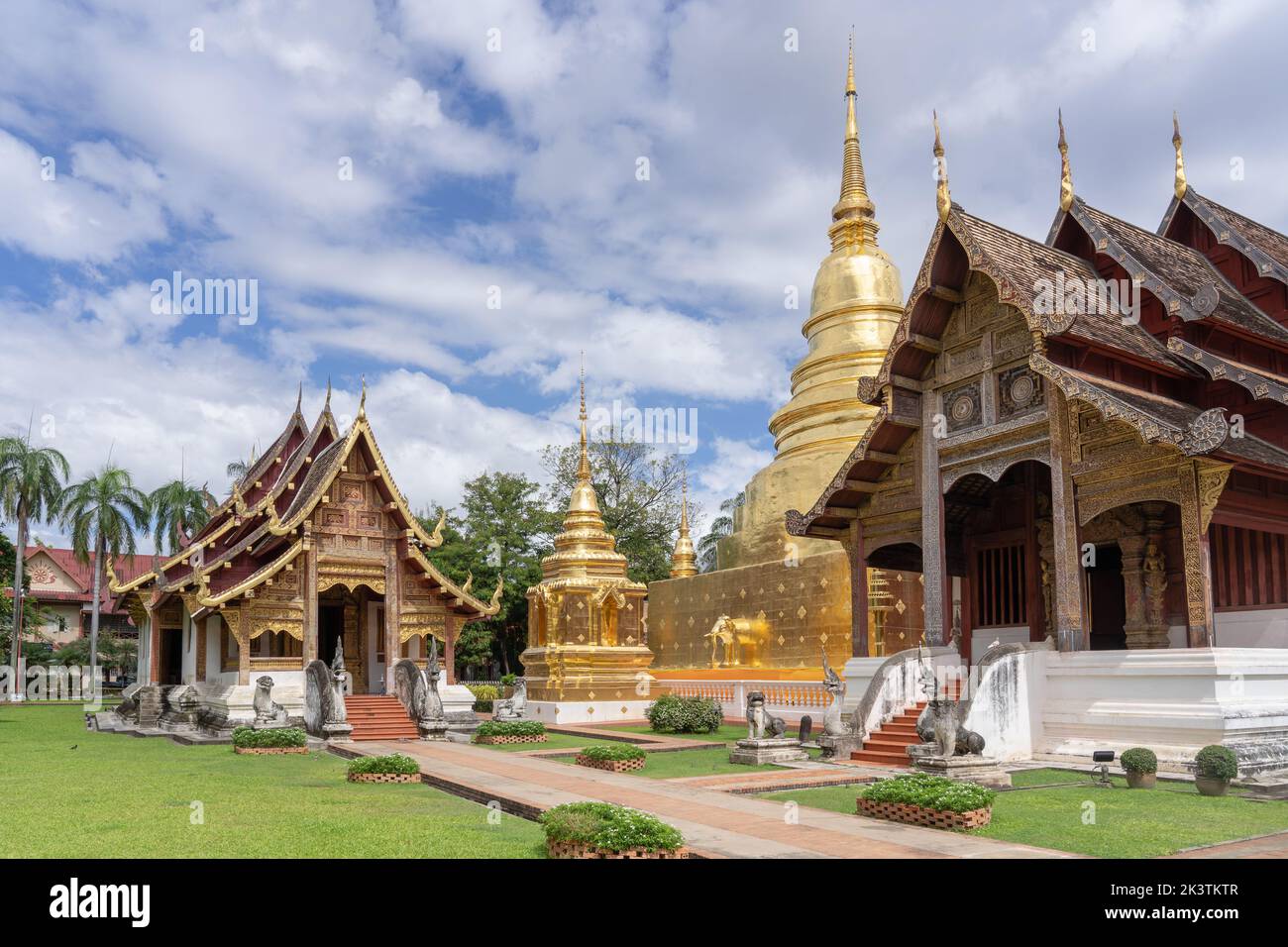 Beautiful panorama view of ubosot and golden stupa inside compound of ...