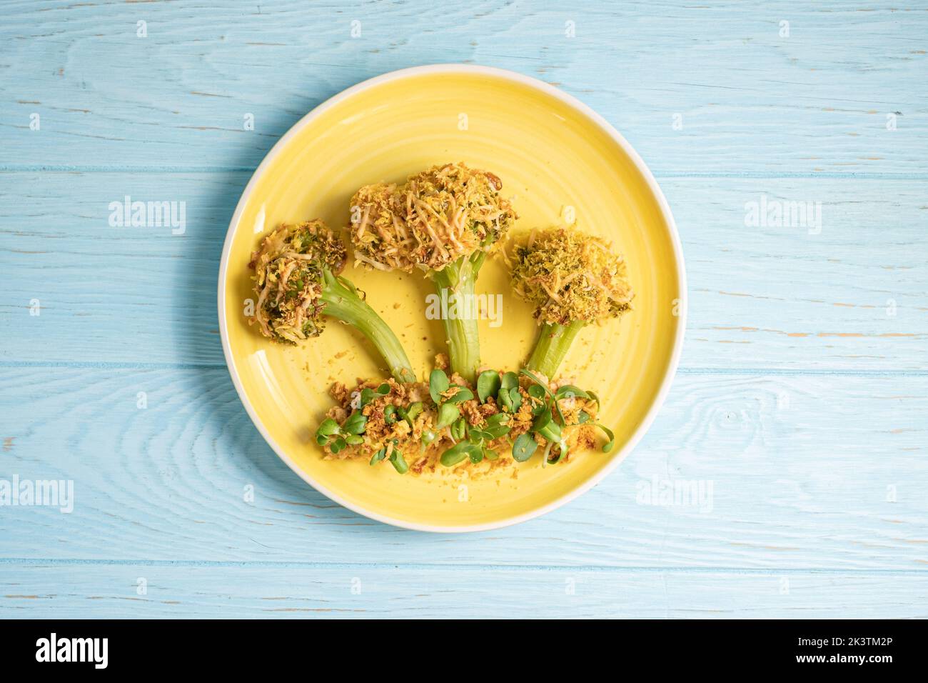 Kids food. Baked broccoli look like trees with hummus and sprout, ready to eat. Stock Photo