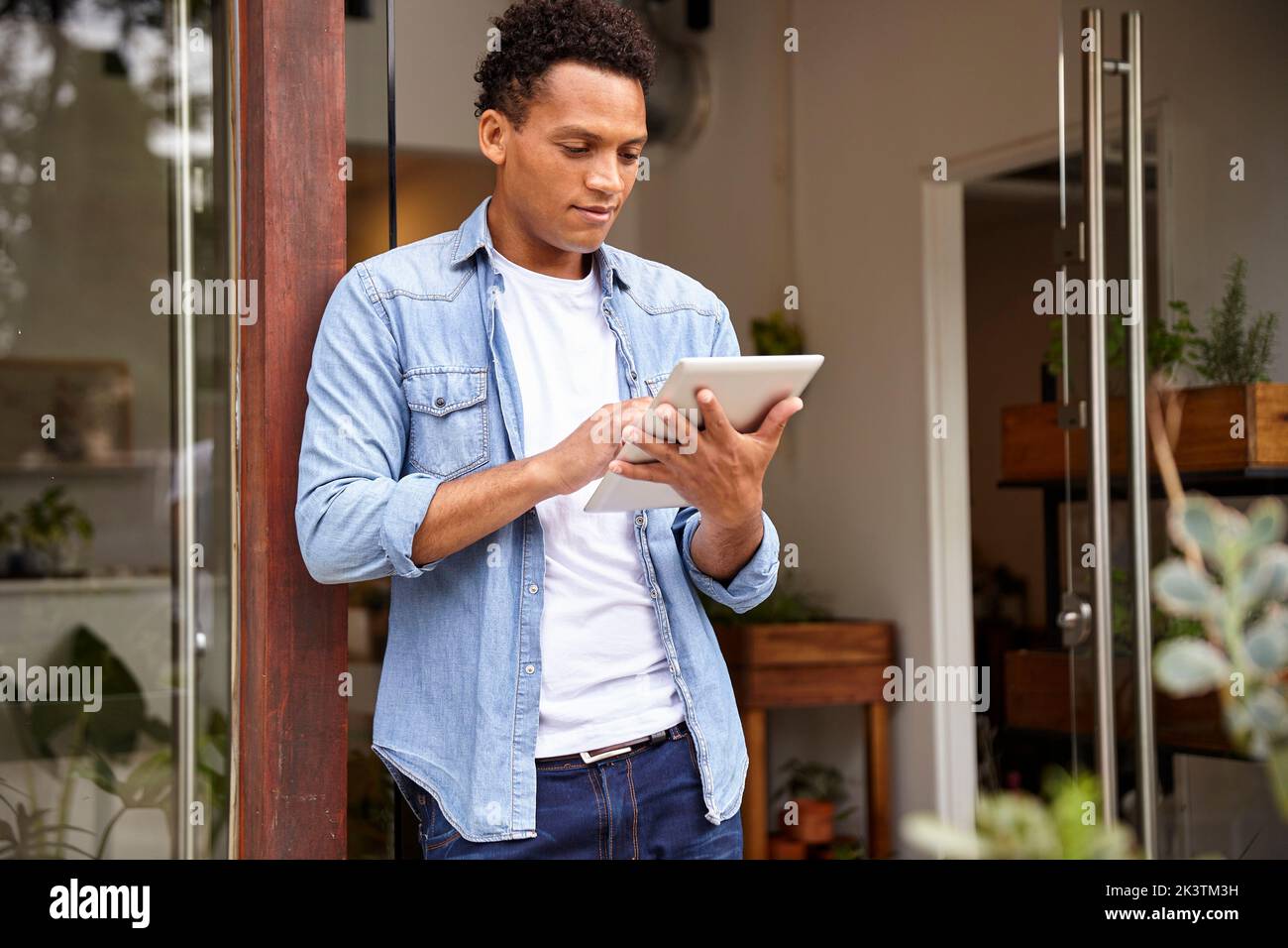 Latin American plant nursery worker using digital tablet Stock Photo