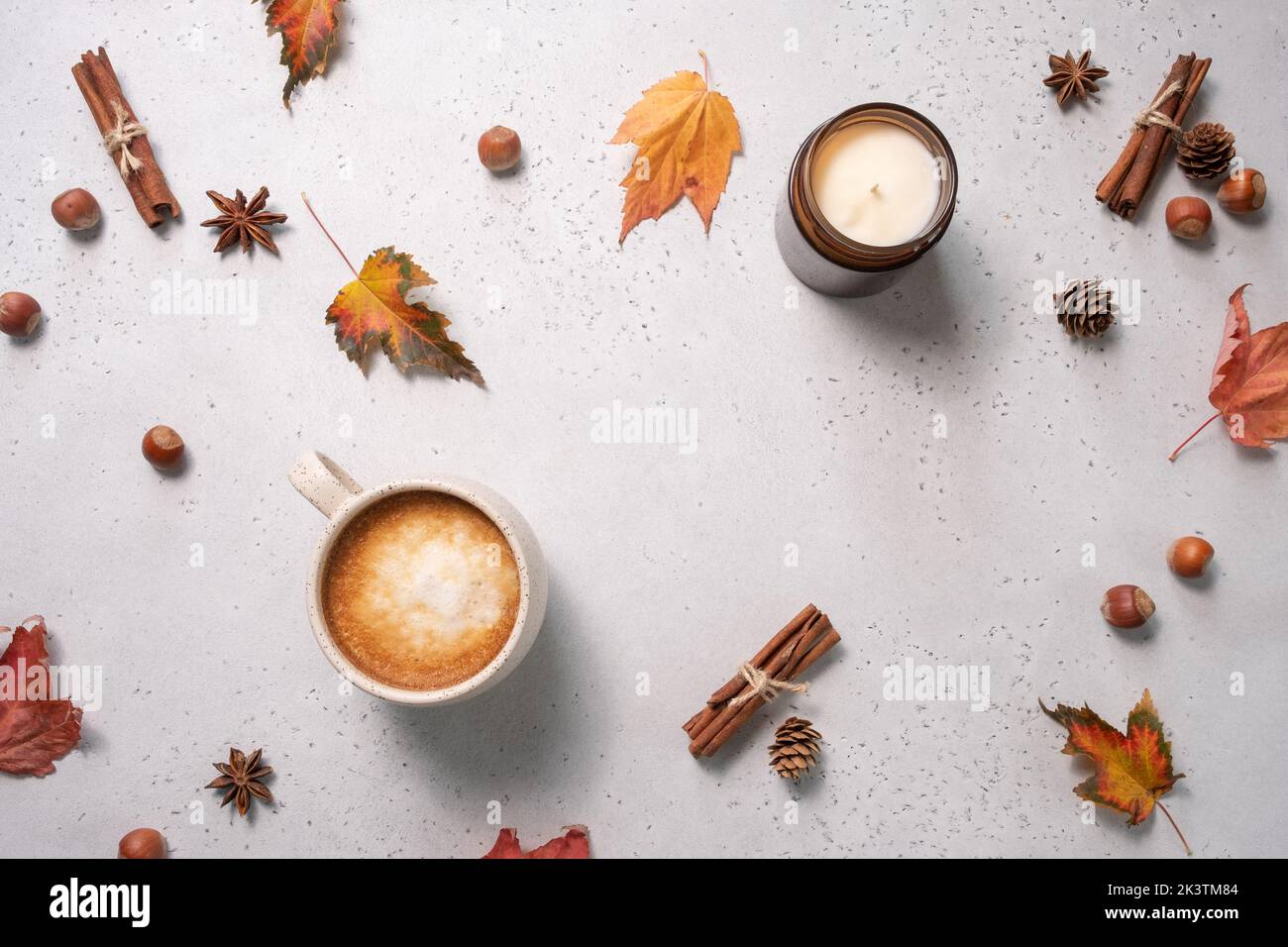 Autumn composition. Cup of coffee, blanket, autumn leaves, cinnamon sticks on white background. Flat lay, top view. Stock Photo