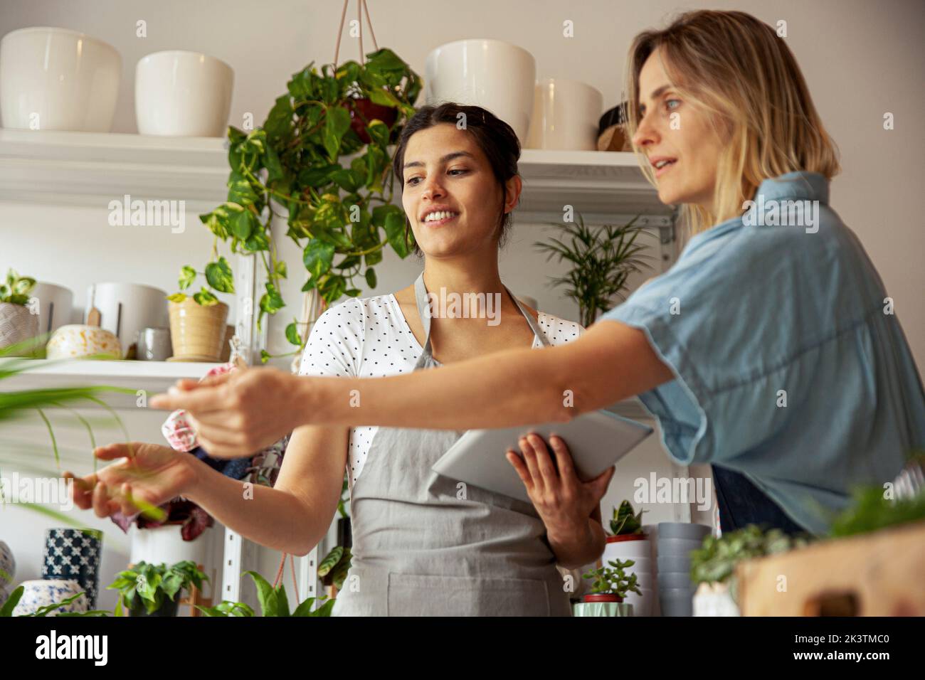 Flower shop owners checking on plant states Stock Photo